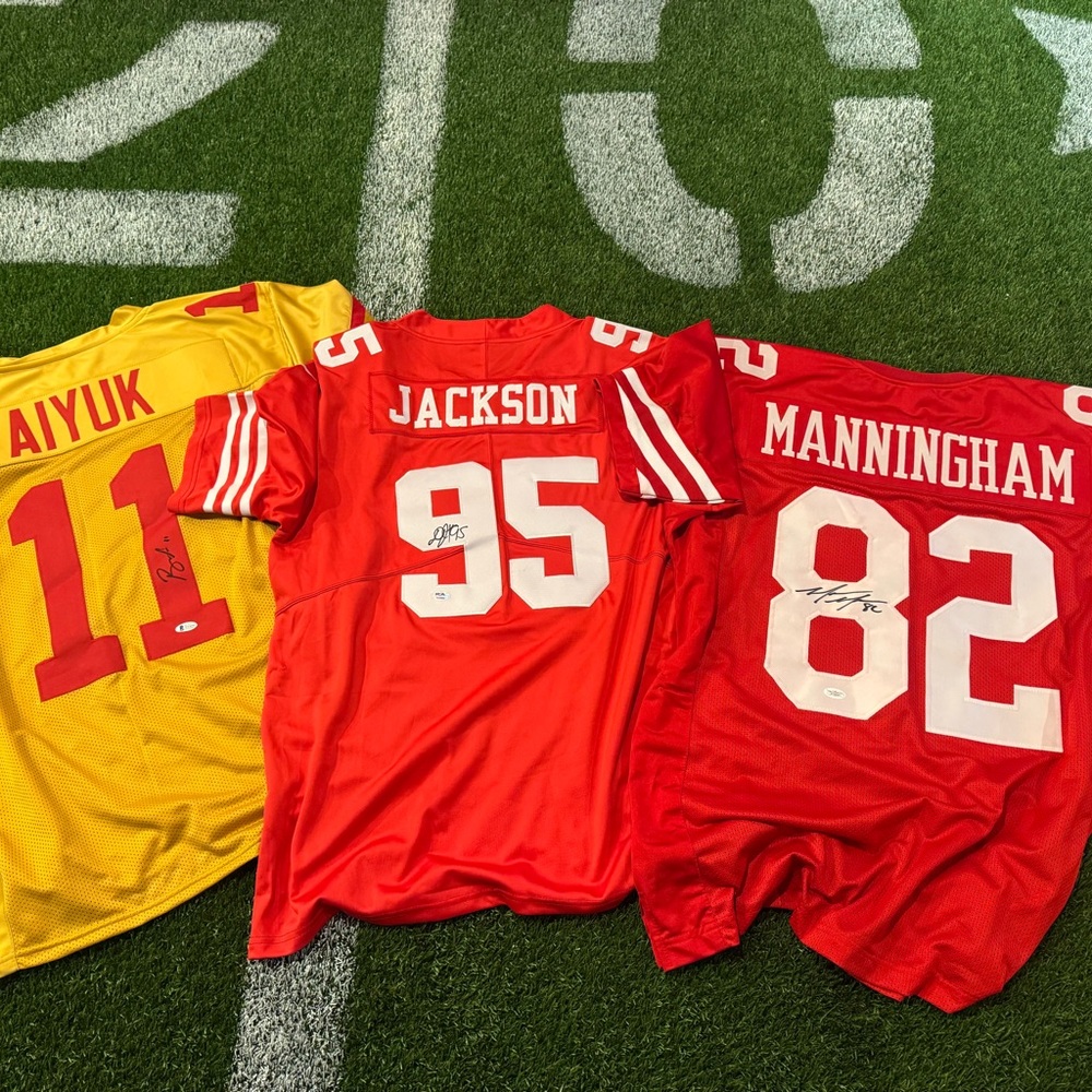 Red and Yellow Football JerseysLot of 3 autographed jerseys.